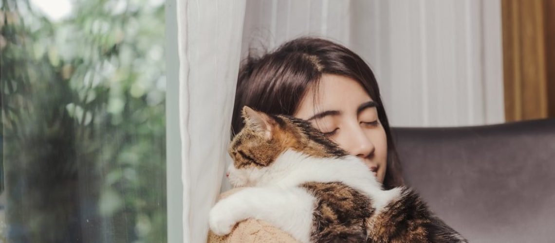 Woman-owner-hugging-cat_Wanwajee-Weeraphukdee_Shutterstock-2